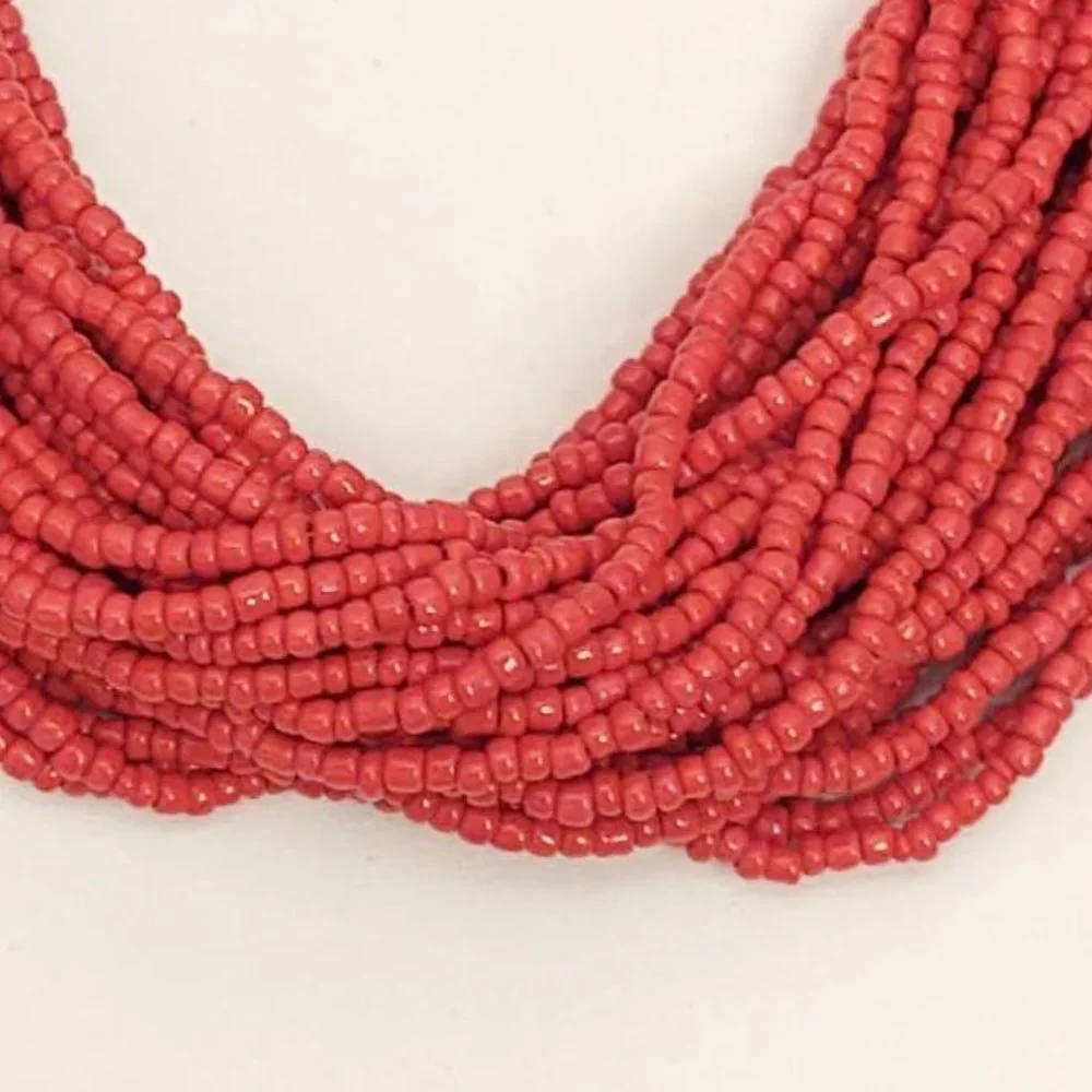 Layered orange beaded necklace with old coin toggle closure